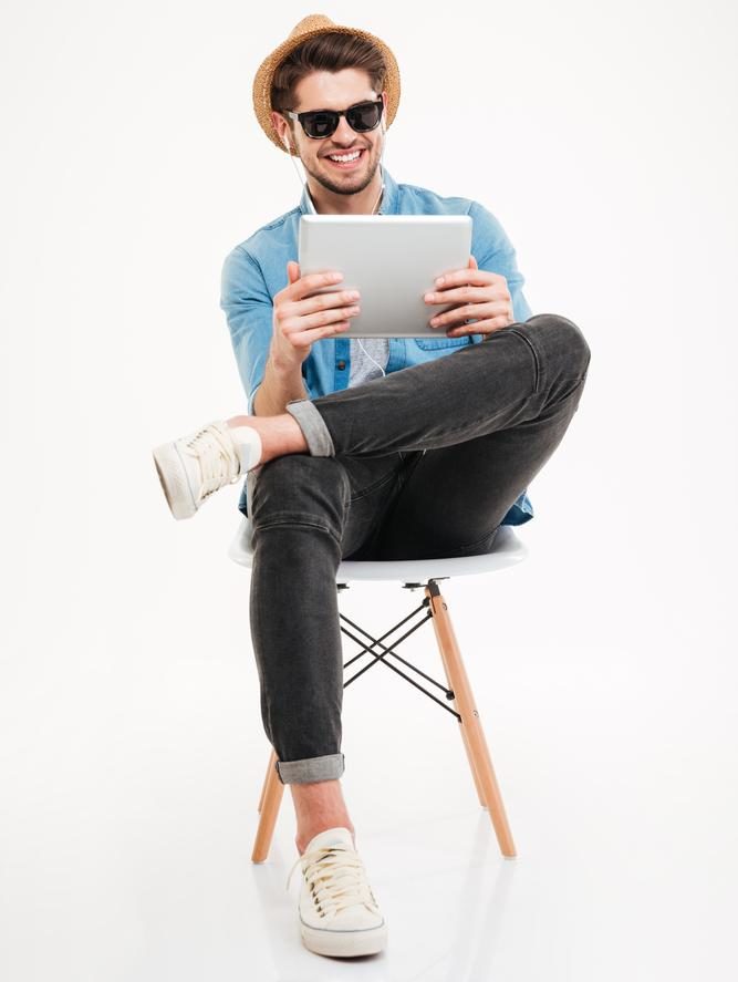 Man smiling at tablet