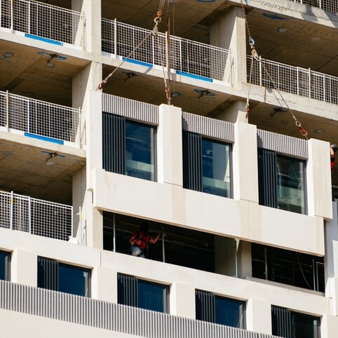 Installing a piece of a modular facade on a building under construction